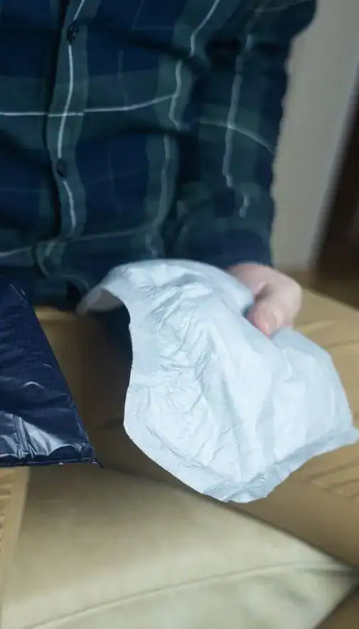 Image of man holding incontinence pads as part of overactive bladder treatment Bournemouth