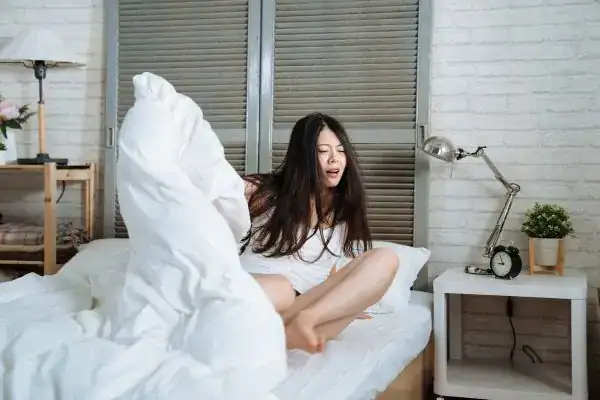 Image of woman getting up because of nighttime leaks Bournemouth